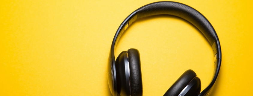 Black headphones on a bright yellow background