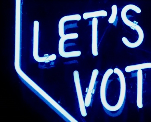 Light blue lights that spell out Let's Vote.