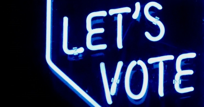 Light blue lights that spell out Let's Vote.