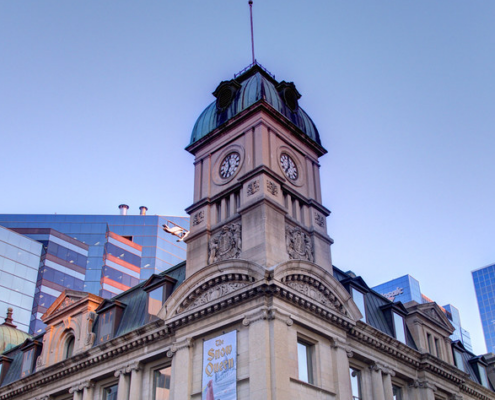 exterior of the globe theatre - the clock tower against Regina Skyline