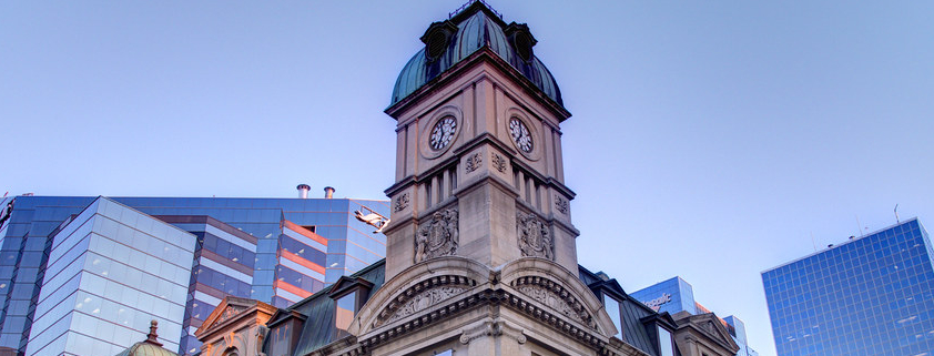 exterior of the globe theatre - the clock tower against Regina Skyline